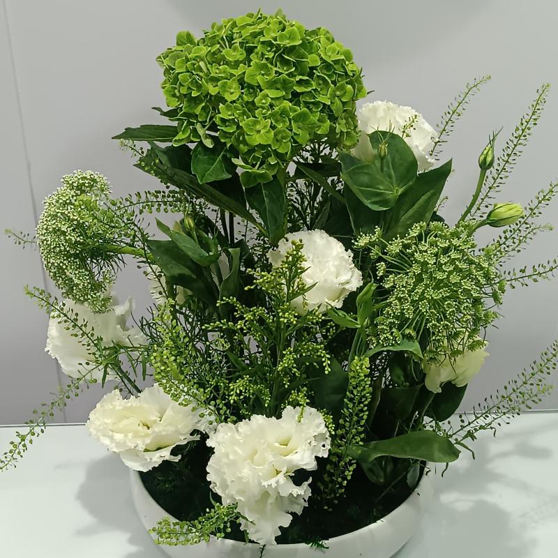 Vase Plate vase with green and white flowers